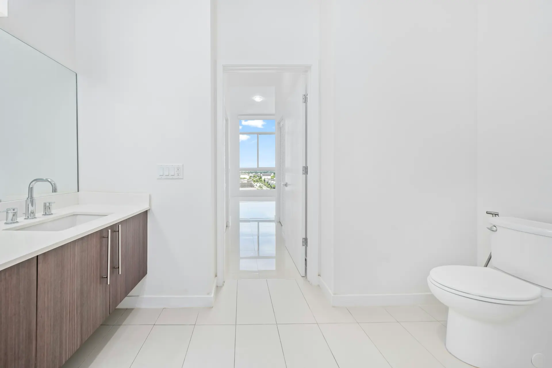 Bright bathroom with clean white floor tiles